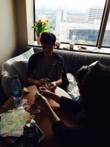 Emily doing origami with the MD Anderson Artist-in-Residence.